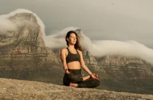 A woman meditating on a rock