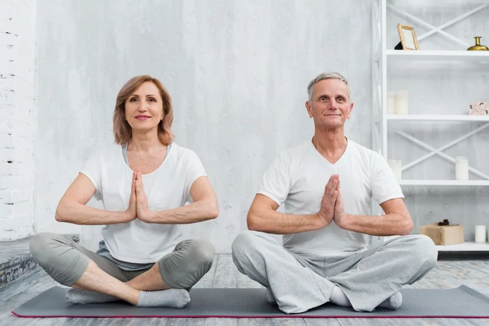 An older couple demonstrating how meditation can enhance emotional connection in relationships.